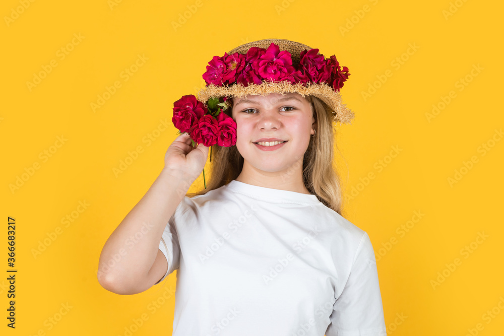 Good plant. happy childhood. female hairdresser salon. beautiful girl with flowers. little girl wear hat with pink fresh blossoming roses. flower composition. girl in straw hat on yellow background