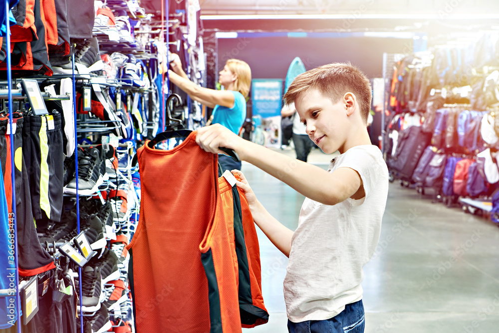 Boy with red t-shirt in basketball sport shop