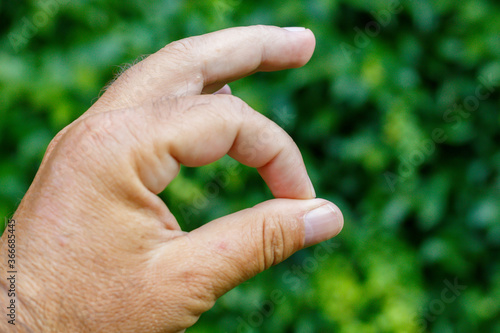 Man Hand With Fingers Forming Shape "O" © bojanzivkovic