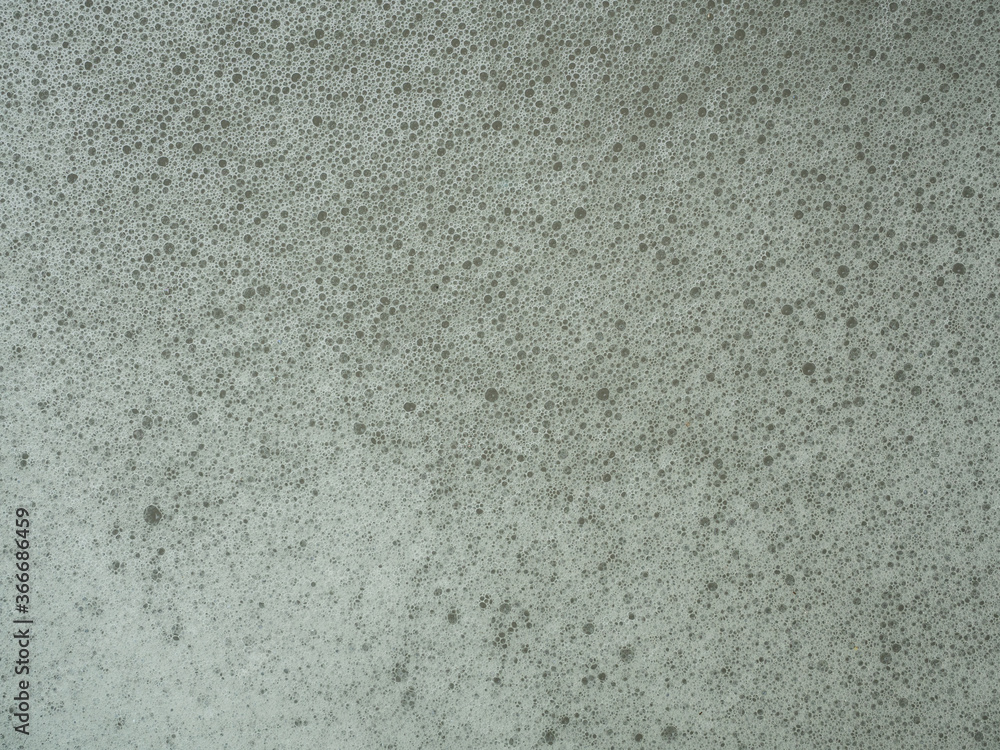 White bubbles and foam on the black color water surface, The condition of wastewater that needs to be treated White bubbles and foam on the black color water surface, The condition of wastewater that needs to be treated