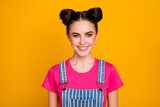 Photo of pretty brunette lady teenager two cute buns good mood beaming smile wear casual striped denim overall magenta t-shirt isolated bright yellow color background