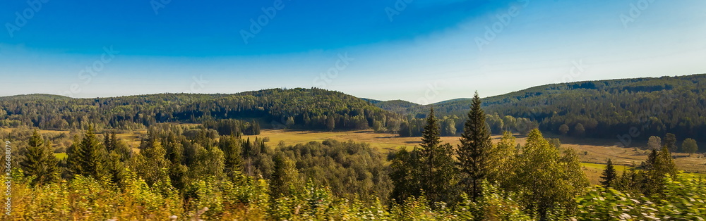 Summer rural landscape with hills, forest, sky