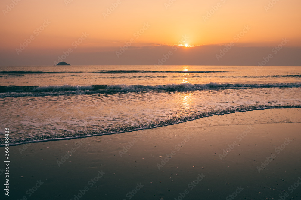 Beautiful golden sunset with blue sky over the horizon on the beach background, Thailand. Tropical twilight colorful sunrise from the landscape sea. Summer vacation concept.