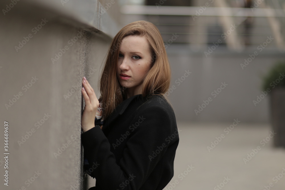 The girl in black coat. Beautiful emotional young girl in the city. Shawl or handkerchief on a person. The girl in black coat. Beautiful emotional young girl in the city. Shawl or handkerchief on a person.