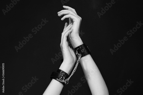 female hands in handcuffs. slave Woman in dark