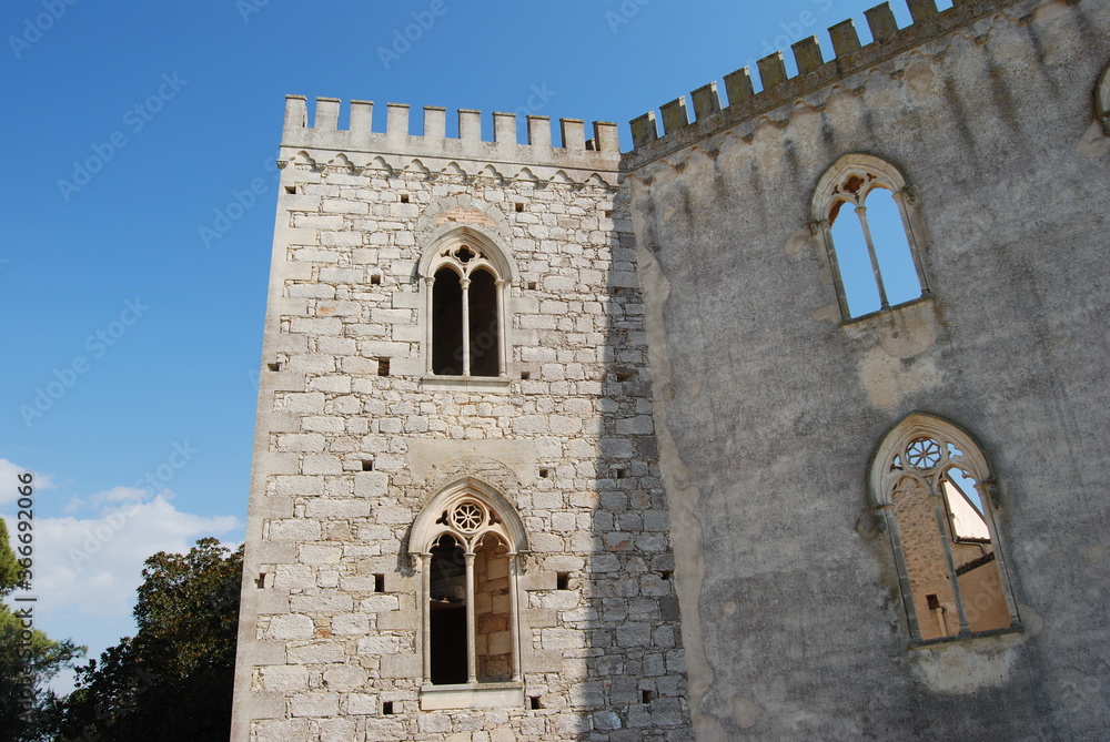 
white castle facade with arched windows and battlements