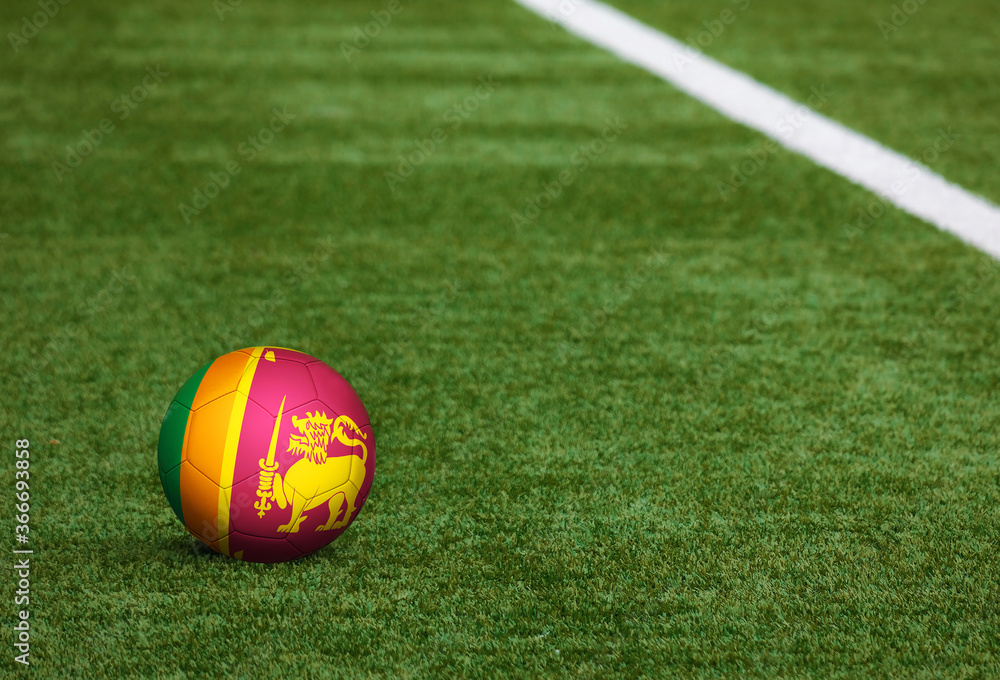 Sri Lanka flag on ball at soccer field background. National football theme on green grass. Sports competition concept. Sri Lanka flag on ball at soccer field background. National football theme on green grass. Sports competition concept.