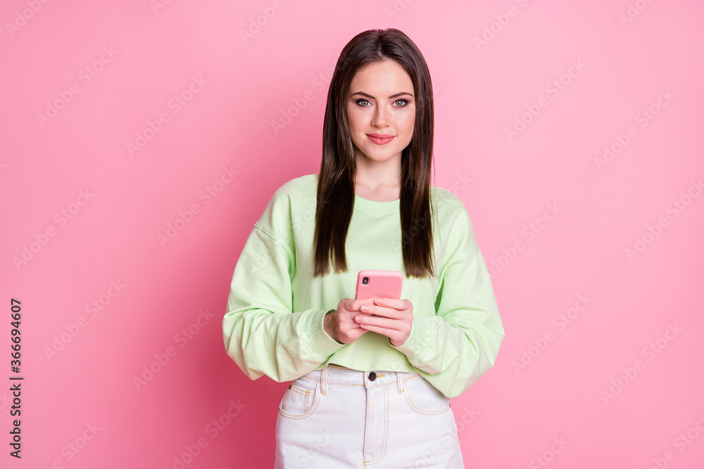 Portrait of positive girl use smartphone enjoy social network communication wear white green clothes sweater isolated over pastel color background Portrait of positive girl use smartphone enjoy social network communication wear white green clothes sweater isolated over pastel color background