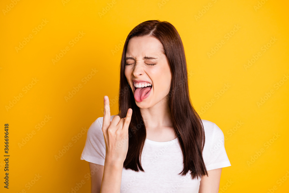 Portrait of crazy punk rocker girl enjoy weekend concert close eyes make horned symbol show tongue-out wear good look outfit isolated over shine color background Portrait of crazy punk rocker girl enjoy weekend concert close eyes make horned symbol show tongue-out wear good look outfit isolated over shine color background