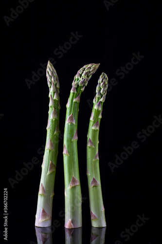 Fresh organic green asparagus  isolated on black background. closeup shot