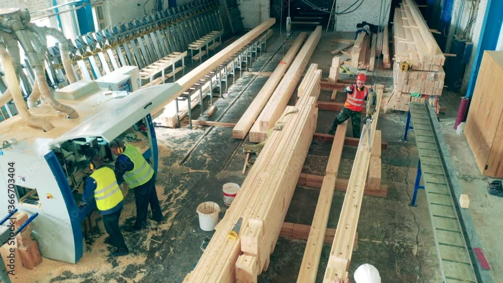Top view of wooden balks getting relocated in factory premises Top view of wooden balks getting relocated in factory premises