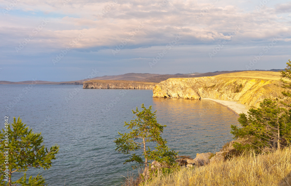Baikal Lake. Beautiful landscape of the coast of Olkhon Island in the sunset light. Natural background. Summer travel