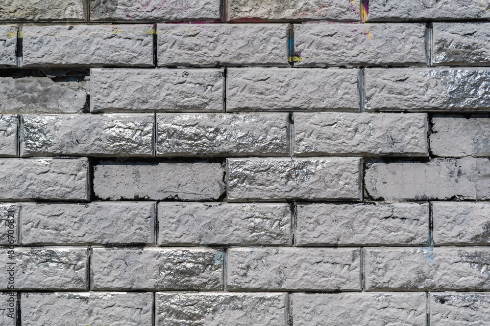 Fototapeta premium Gray stone wall with silver inserts