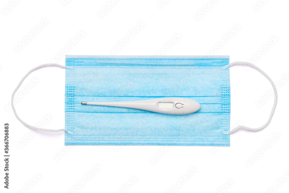 bottle of lotion, sanitizer or liquid soap, electronic thermometer and protective mask over light grey background bottle of lotion, sanitizer or liquid soap, electronic thermometer and protective mask over light grey background