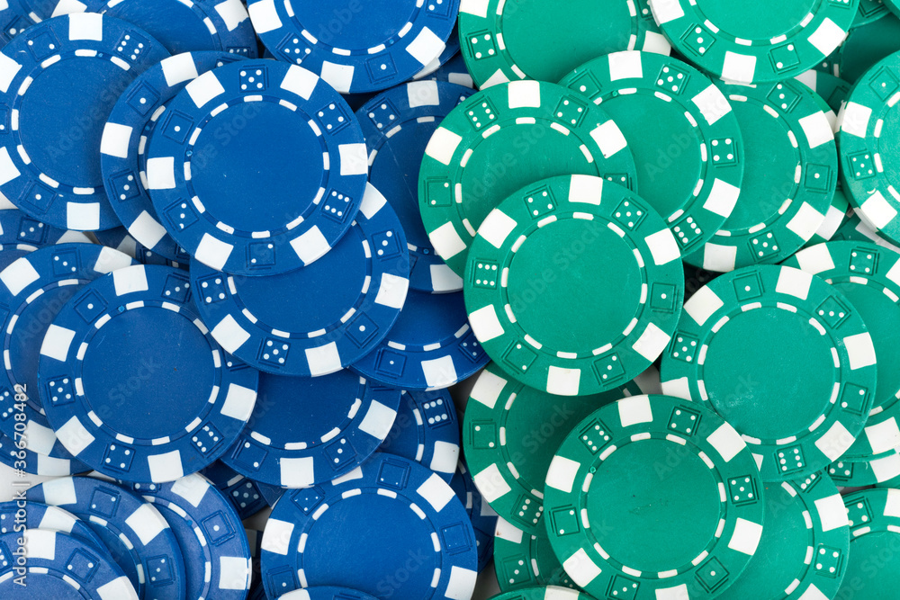Battle Blue versus Green yin vs yang Playing Poker Chips laying on the table mixed together. Abstract Pattern Background Battle Blue versus Green yin vs yang Playing Poker Chips laying on the table mixed together. Abstract Pattern Background