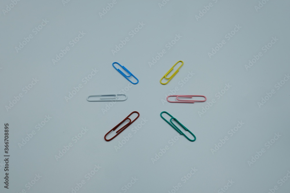 Asterisk shape by paper clips multicolor on white background, office business work or education concept Asterisk shape by paper clips multicolor on white background, office business work or education concept