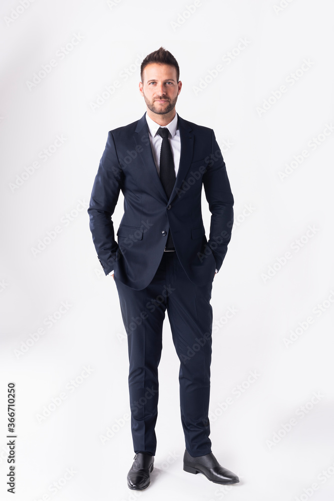 Studio shot of handsome businessman wearing suit while standing at isolated white background Studio shot of handsome businessman wearing suit while standing at isolated white background