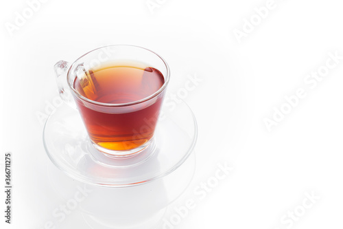 Black tea in a glass cup on a white background