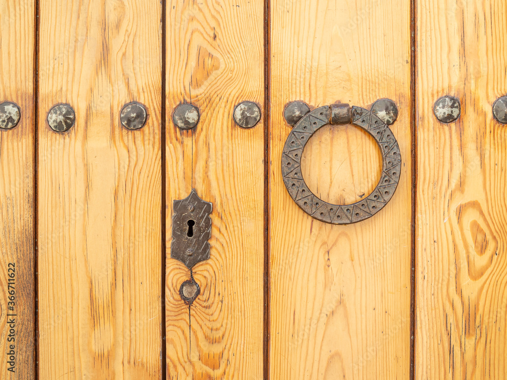 Antique door handle at the wooden door surface Antique door handle at the wooden door surface