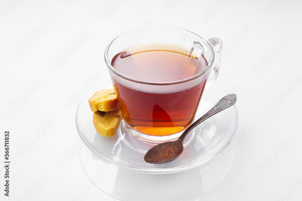 Black tea in a glass cup on a white background Black tea in a glass cup on a white background