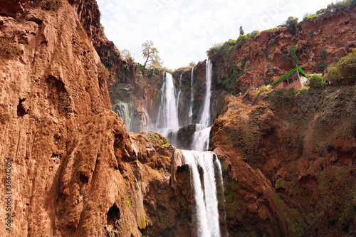 Water falling from Ouzoud waterfalls in an arid terrain.