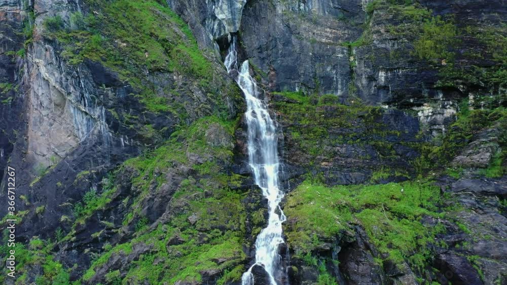 Aerial push, zoom in shot of a wonderful waterfall on the side of a huge cliff, in the mountains. Aerial push, zoom in shot of a wonderful waterfall on the side of a huge cliff, in the mountains.
