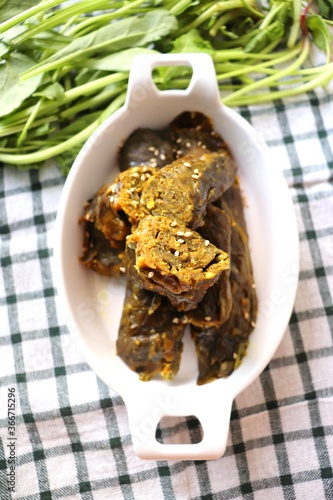 Palak vadi or spinach roll is a Maharashtrian side dish. Its a very tasty and savory preparation similarly like Alu vadi or Patra. healthy steamed rolls garnished with sesame seeds. Copy space.