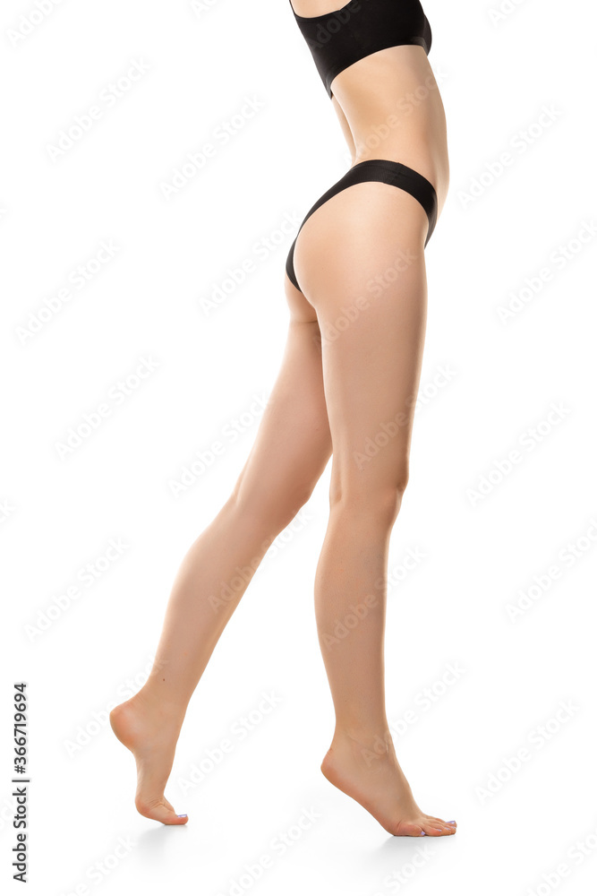 Beautiful female legs, buttlocks and belly isolated on white background. Beauty, cosmetics, spa, depilation, treatment and fitness concept. Sportive, sensual body with well-kept skin in underwear. Beautiful female legs, buttlocks and belly isolated on white background. Beauty, cosmetics, spa, depilation, treatment and fitness concept. Sportive, sensual body with well-kept skin in underwear.