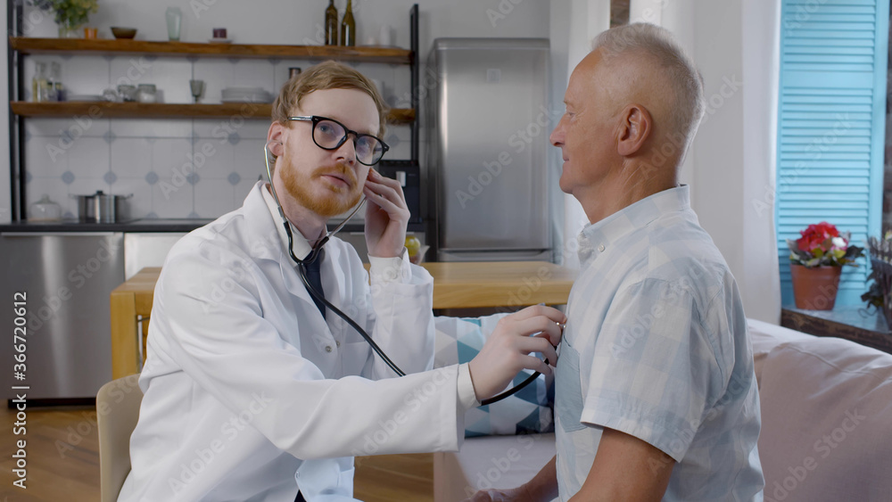Obraz premium Doctor consulting older man patient during visit at home