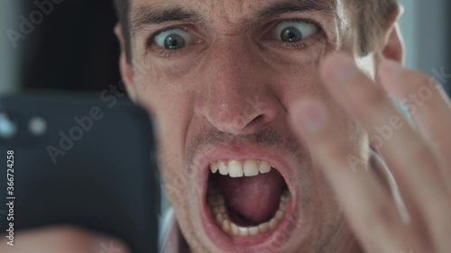 Angry troubled stressed business man having problem while using smartphone