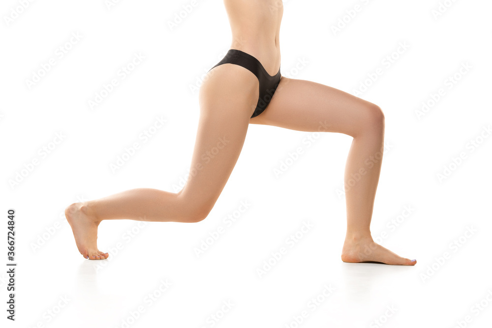 Beautiful female legs, buttlocks during sport isolated on white background. Beauty, cosmetics, spa, depilation, treatment and fitness concept. Sportive, sensual body with well-kept skin in underwear. Beautiful female legs, buttlocks during sport isolated on white background. Beauty, cosmetics, spa, depilation, treatment and fitness concept. Sportive, sensual body with well-kept skin in underwear.