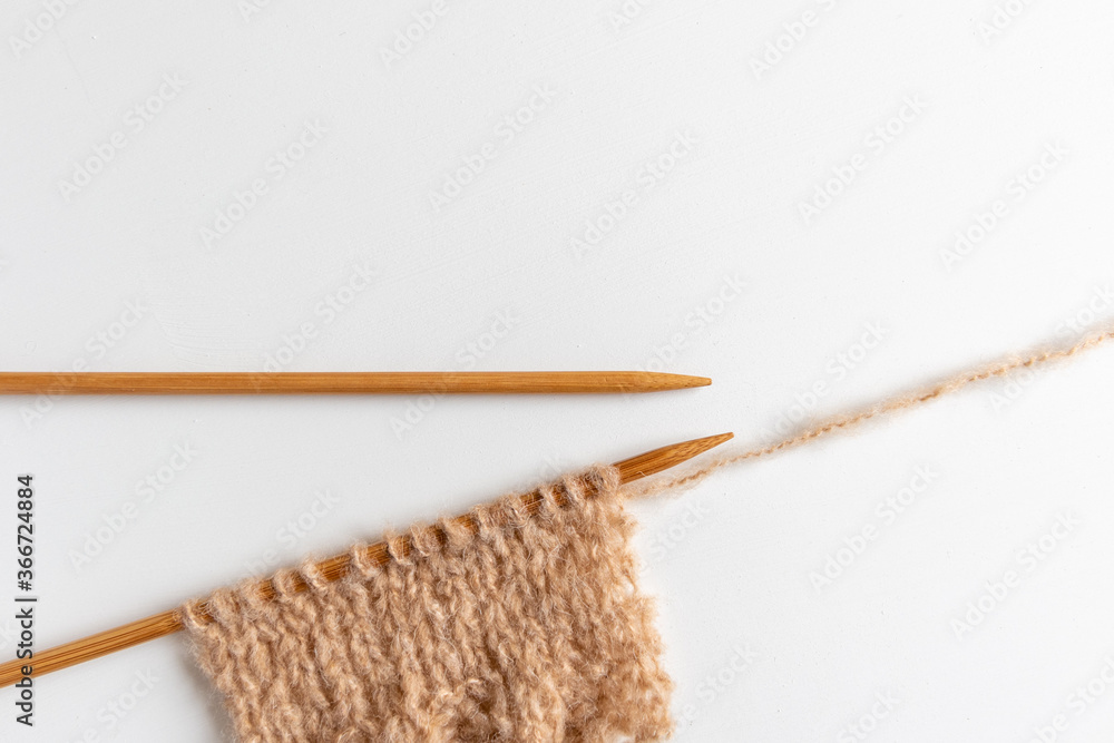wooden knitting needles and beige mohair yarn wooden knitting needles and beige mohair yarn