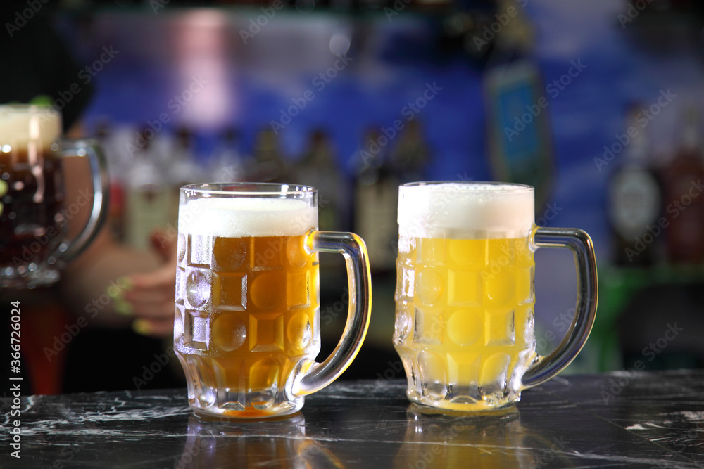Glasses with different sorts of craft beer. Red, bronze and white beer in beer glasses on the bar. Glasses of light and dark beer on a pub background. Glasses with different sorts of craft beer. Red, bronze and white beer in beer glasses on the bar. Glasses of light and dark beer on a pub background.