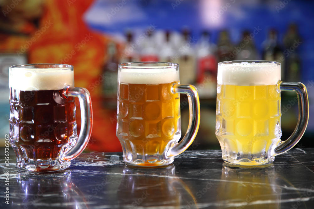 Glasses with different sorts of craft beer. Red, bronze and white beer in beer glasses on the bar. Glasses of light and dark beer on a pub background. Glasses with different sorts of craft beer. Red, bronze and white beer in beer glasses on the bar. Glasses of light and dark beer on a pub background.