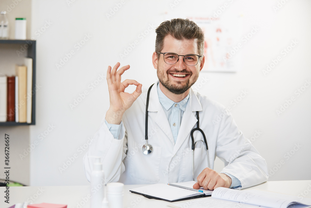 physician showing ok gesture and smiling to camera physician showing ok gesture and smiling to camera