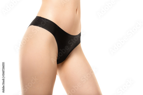 Close up. Beautiful female legs, buttlocks isolated on white background. Beauty, cosmetics, spa, depilation, treatment and fitness concept. Sportive, sensual body with well-kept skin in underwear.