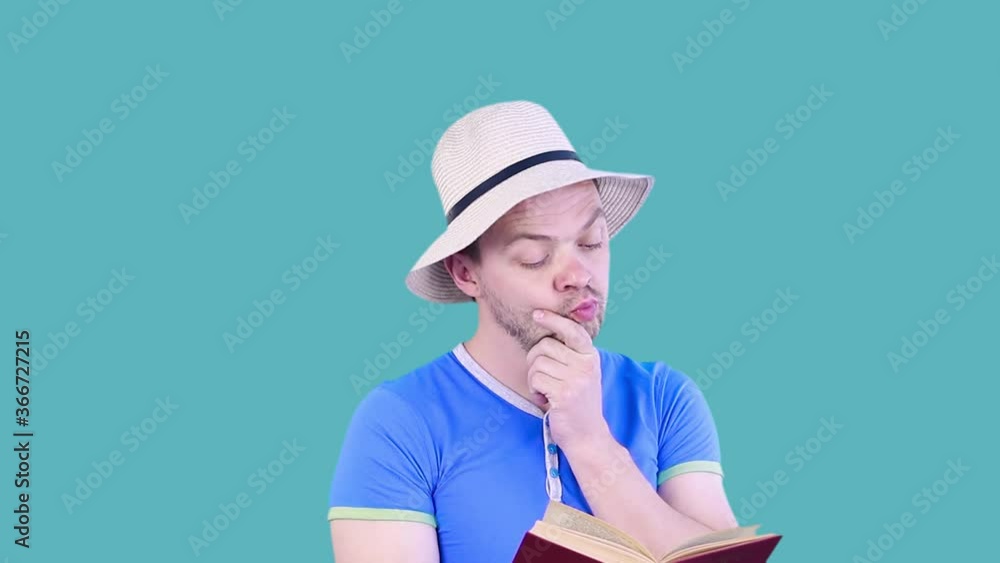 Funny man with a book in his hands isolated on blue background. Funny man with a book in his hands isolated on blue background.