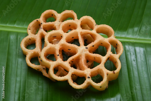 Indian fried snack Achappam or Rosette Cookie is a traditional and popular deep fried snack at tea time Kerala India during festival christmas, Onam, Vishu. is crunchy, sweet in flower shape