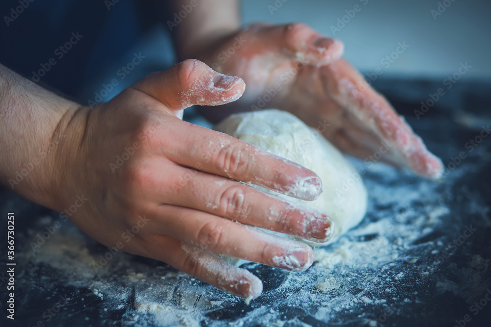 Cook hands soiled in flour knead wheat dough for bread. Home cooking. Cook hands soiled in flour knead wheat dough for bread. Home cooking.
