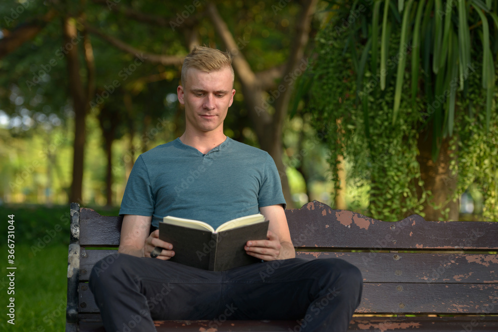 Young man with blond hair at the park outdoors Young man with blond hair at the park outdoors
