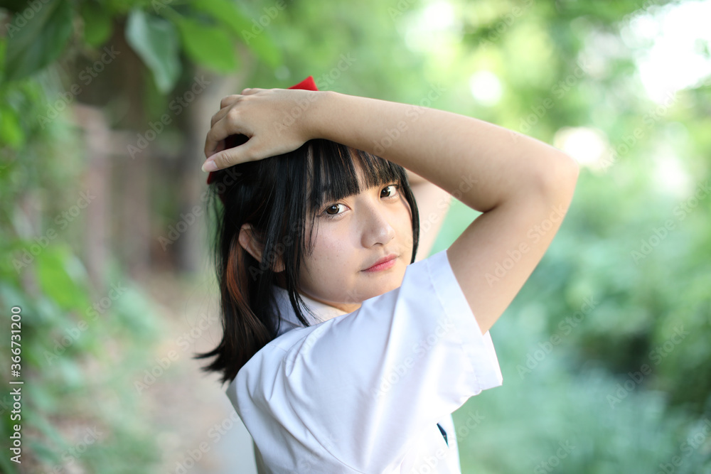 Asian school girl walking and looking in urban city with tree background Asian school girl walking and looking in urban city with tree background