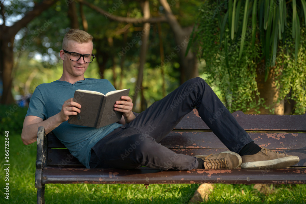 Fototapeta premium Young man with blond hair at the park outdoors