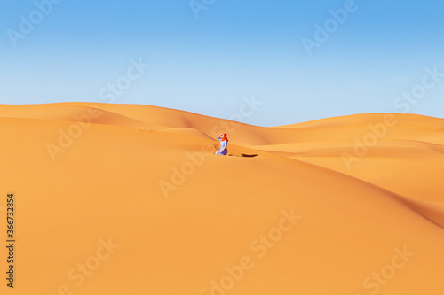 Beautiful girl in the Sahara desert.