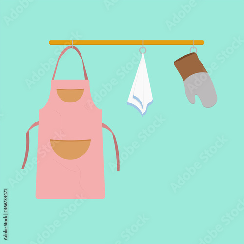 Apron, pot holder and towel for kitchen and cooking on a gold holder