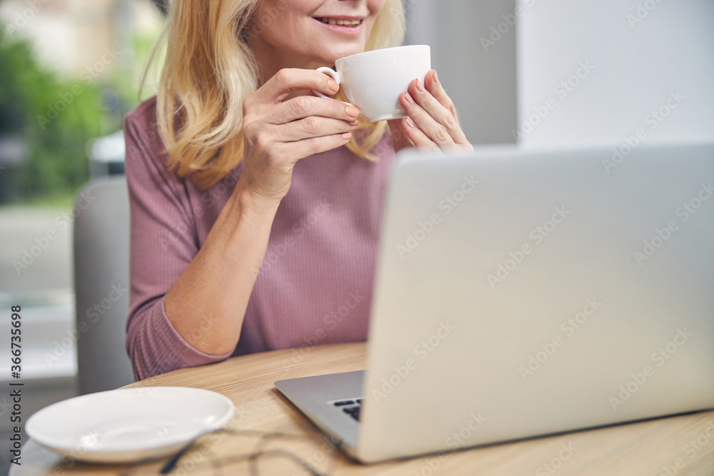 Close up of delighted woman drinking aroma coffee Close up of delighted woman drinking aroma coffee