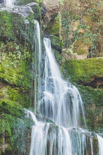 Majestic waterfall in deep forest. River forest scene. Wild  vivid vegetation. Beautiful landscape in Sintra  Portugal