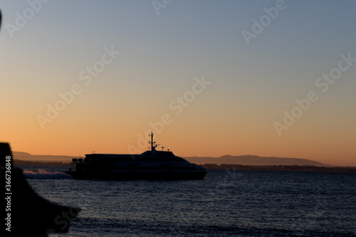 Abstract Ferryboat golden hour during sun rise with sunlight. Perfect silhouette with city lines and ferry boat. Lisbon. © Diogo Oliveira