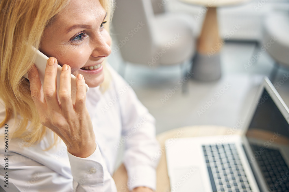 Close up of tender woman having pleasant conversation Close up of tender woman having pleasant conversation