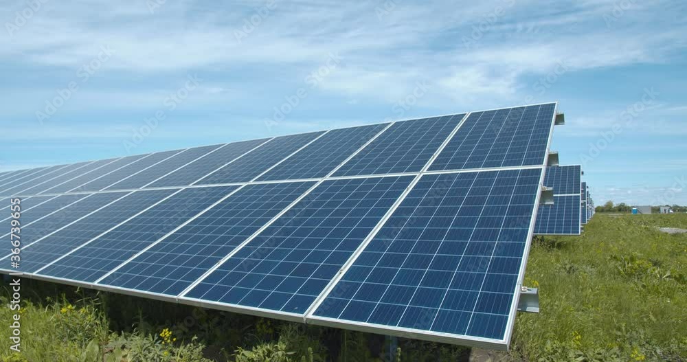 Lots of rows of the solar panels at the power station, nature around them, 4k Lots of rows of the solar panels at the power station, nature around them, 4k