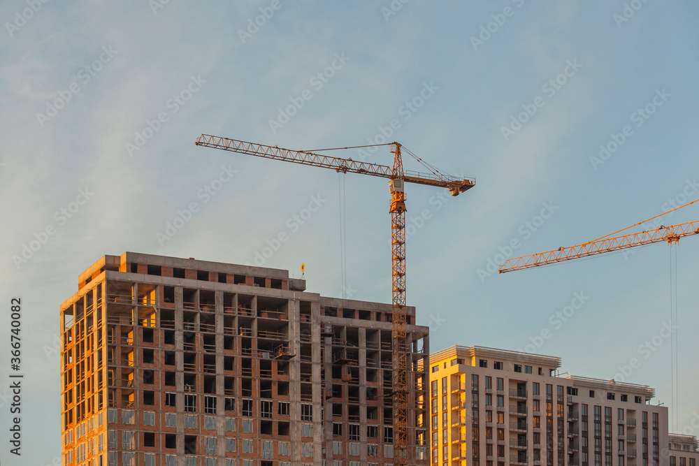 Fototapeta premium construction site with cranes against the blue sky